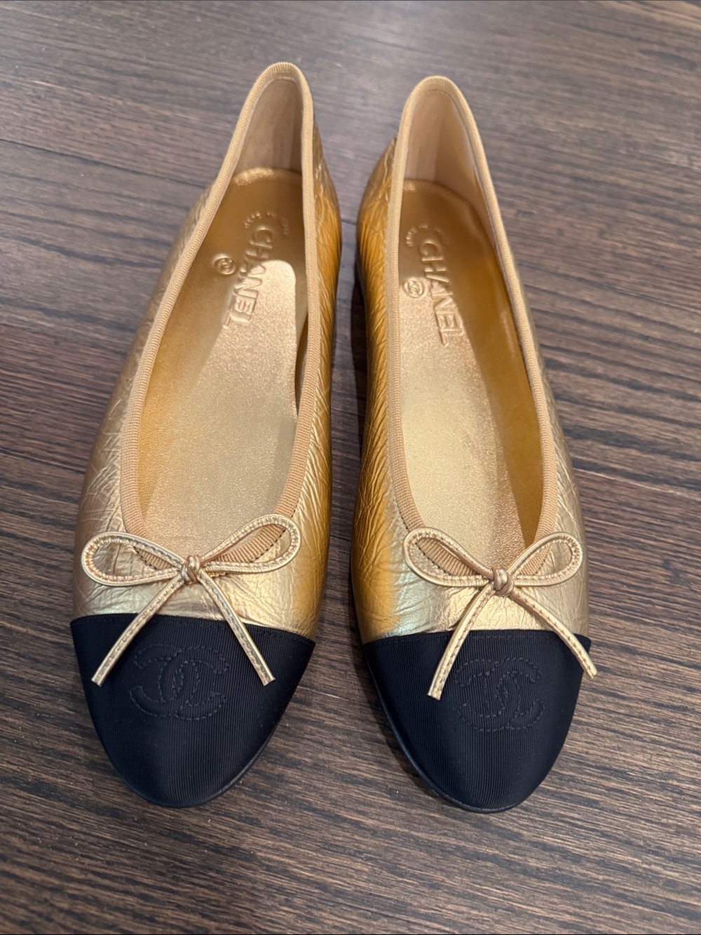 CHANEL Gold Leather Ballet Flats with Black Cap Toe